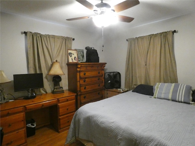 bedroom with ceiling fan and hardwood / wood-style floors