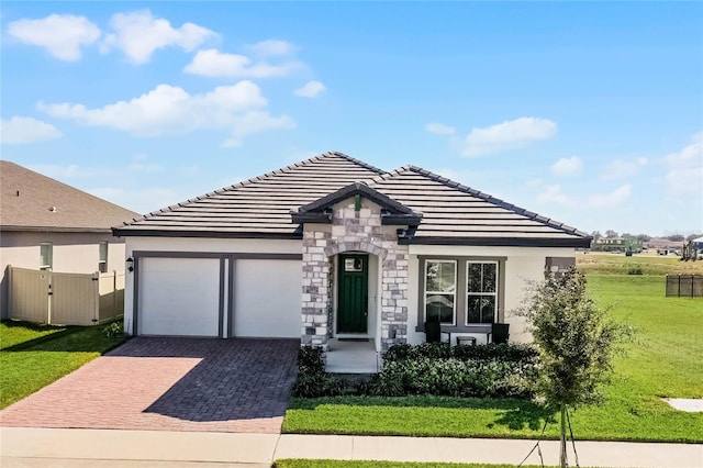 view of front of property featuring a garage and a front lawn