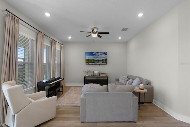 living room featuring ceiling fan and light wood-type flooring