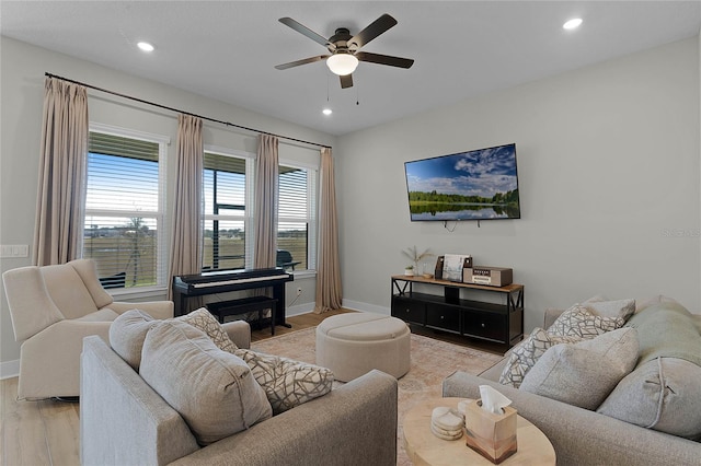 living room featuring light hardwood / wood-style floors and ceiling fan