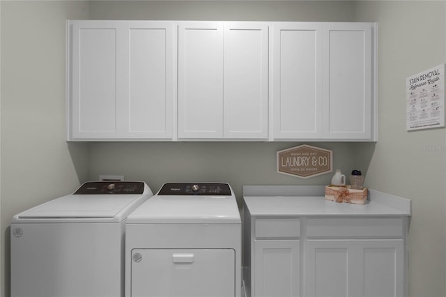 laundry room featuring cabinets and separate washer and dryer