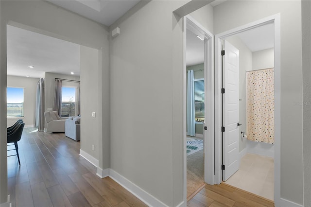 hallway with light hardwood / wood-style floors