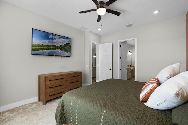 carpeted bedroom featuring connected bathroom and ceiling fan