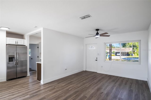 interior space featuring ceiling fan and dark hardwood / wood-style flooring