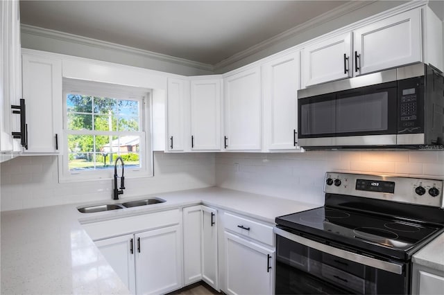 kitchen featuring backsplash, stainless steel appliances, white cabinets, and sink