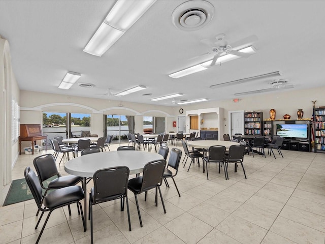 dining area featuring light tile patterned floors, ceiling fan, and visible vents