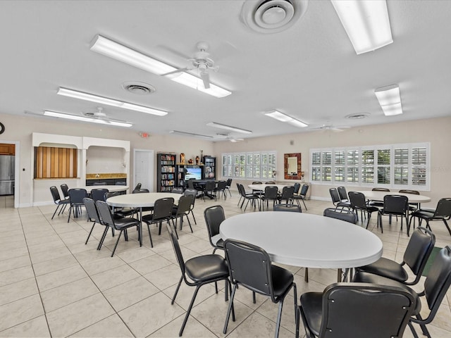 dining area featuring light tile patterned floors, visible vents, and a ceiling fan