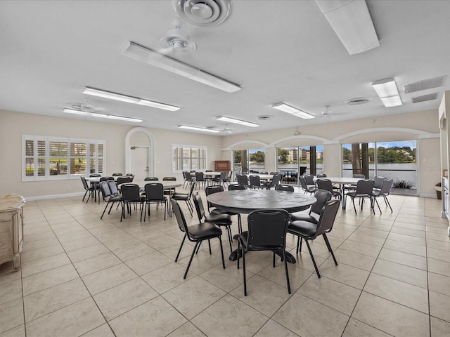 dining space with baseboards, visible vents, and light tile patterned flooring