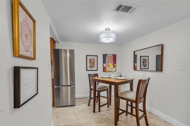 dining area featuring visible vents, baseboards, and light tile patterned floors