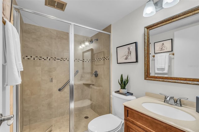 full bath with toilet, vanity, a shower stall, and visible vents