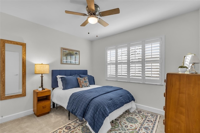 carpeted bedroom featuring ceiling fan and baseboards