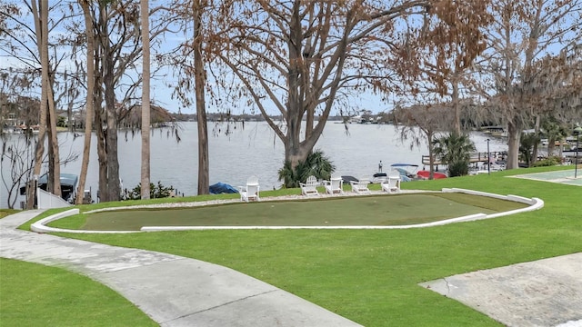 view of community with a lawn and a water view