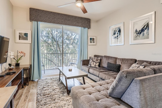 living room with light wood-type flooring and ceiling fan