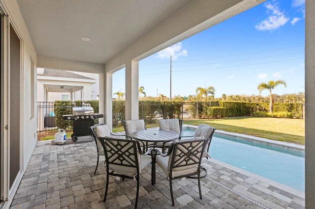 view of patio / terrace with a fenced in pool and grilling area