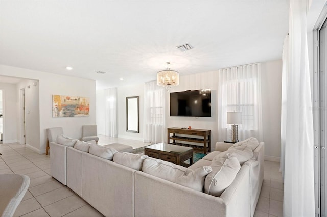 living room with a chandelier and light tile patterned floors