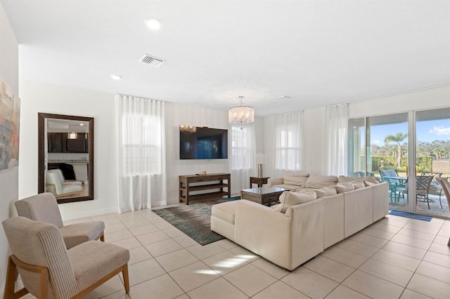 tiled living room featuring a notable chandelier