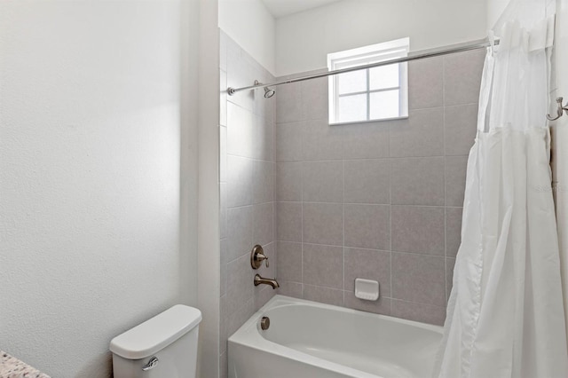 bathroom featuring shower / bath combo and toilet