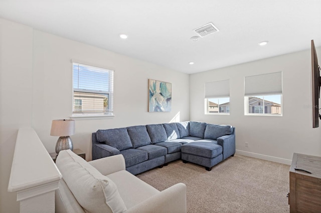 living room with light colored carpet and a healthy amount of sunlight