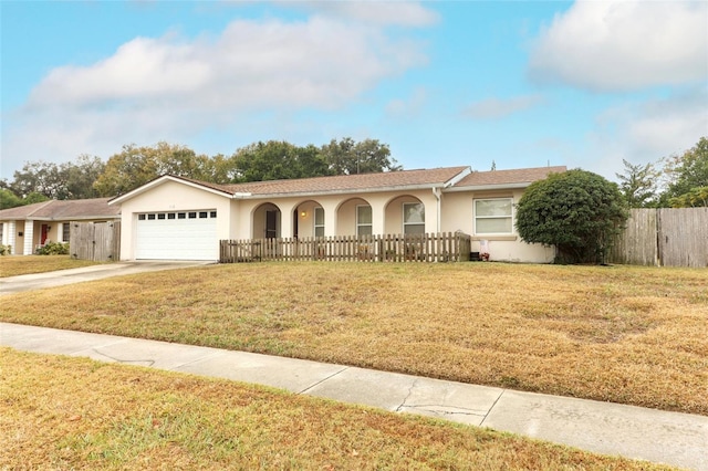 view of front of property with a front lawn and a garage