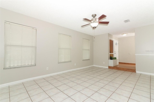 unfurnished room featuring light tile patterned flooring, a textured ceiling, and ceiling fan