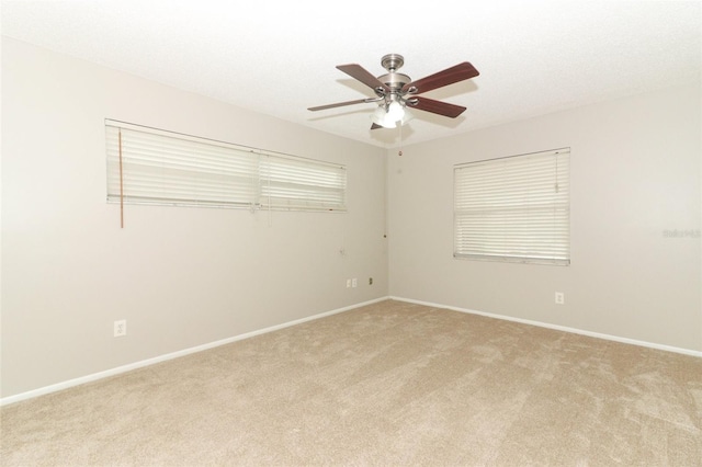 unfurnished room featuring ceiling fan and light colored carpet