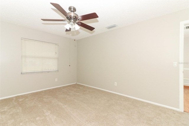 unfurnished room featuring ceiling fan and light carpet