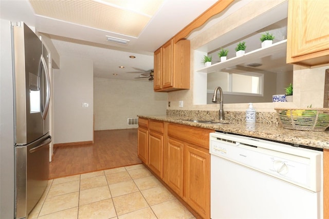 kitchen featuring light stone counters, ceiling fan, light tile patterned floors, white dishwasher, and stainless steel fridge with ice dispenser