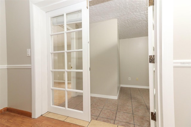 interior space with a textured ceiling and light wood-type flooring