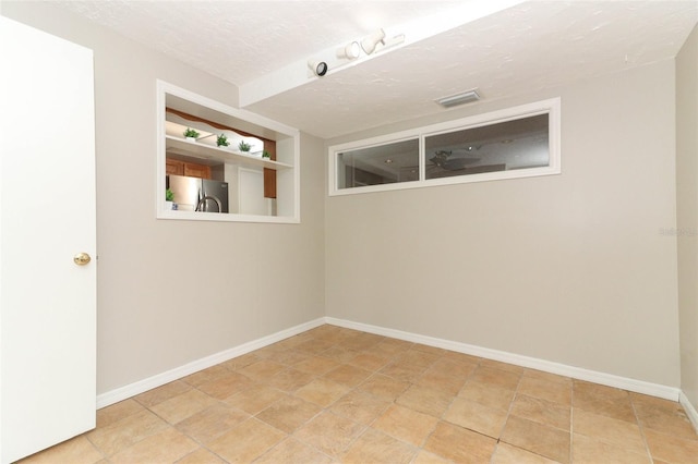 empty room featuring a textured ceiling