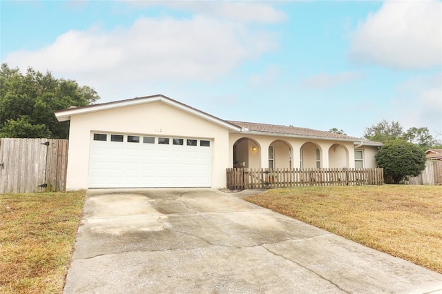 view of front facade with a garage and a front lawn