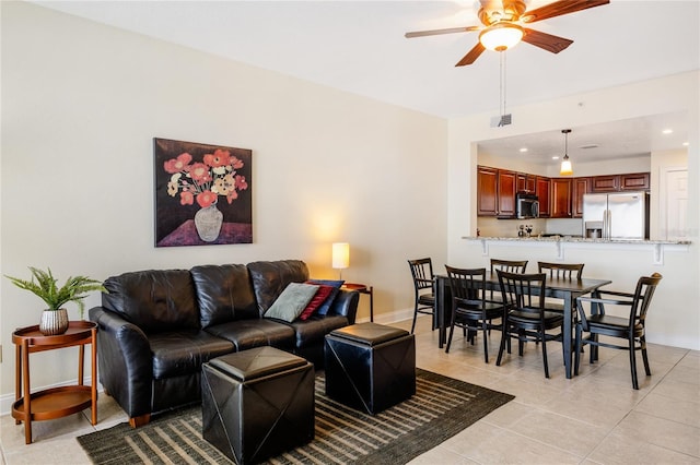 tiled living room with ceiling fan