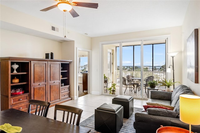 tiled living room featuring ceiling fan