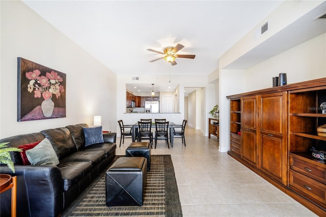 living room featuring light tile patterned floors and ceiling fan