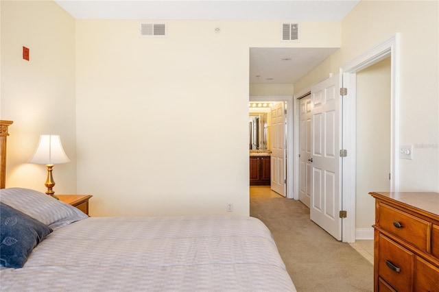 carpeted bedroom featuring ensuite bath