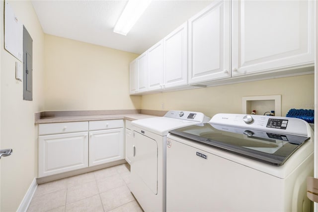 clothes washing area with light tile patterned floors, washer and clothes dryer, electric panel, and cabinets