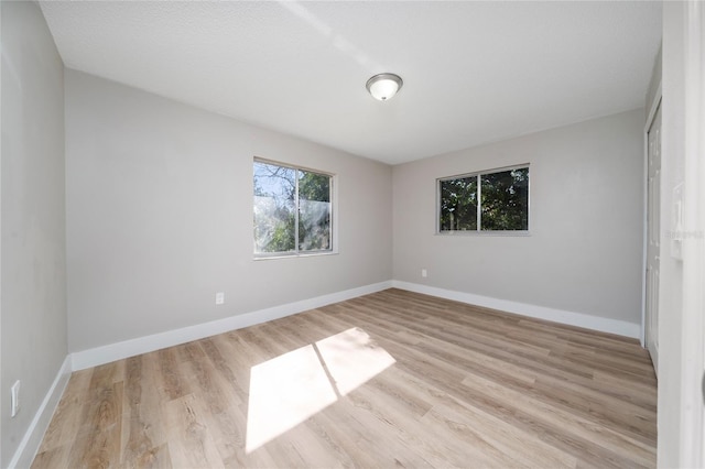 spare room with light hardwood / wood-style floors