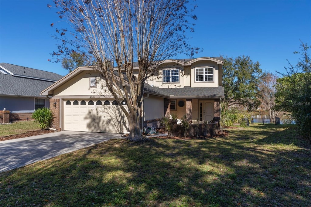 view of front of home with a garage, a porch, and a front yard