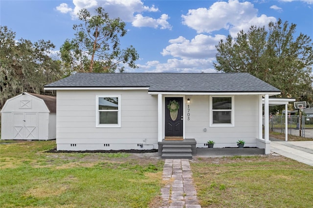 view of front facade featuring a front lawn and a shed