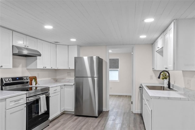 kitchen with white cabinets, appliances with stainless steel finishes, light hardwood / wood-style flooring, and sink