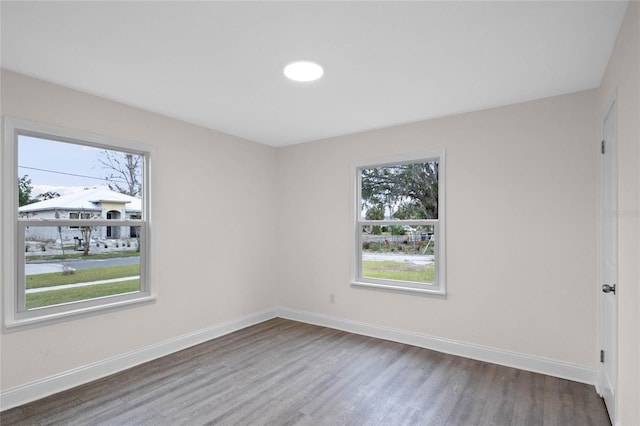 unfurnished room featuring hardwood / wood-style flooring