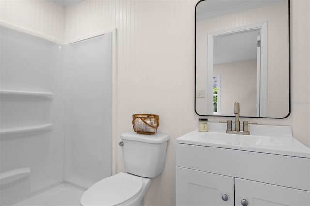 bathroom featuring ornamental molding, a shower, vanity, and toilet