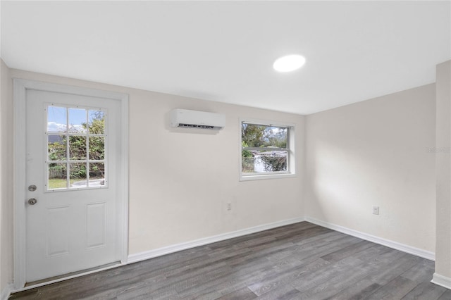 entrance foyer featuring a wall mounted air conditioner and dark hardwood / wood-style floors