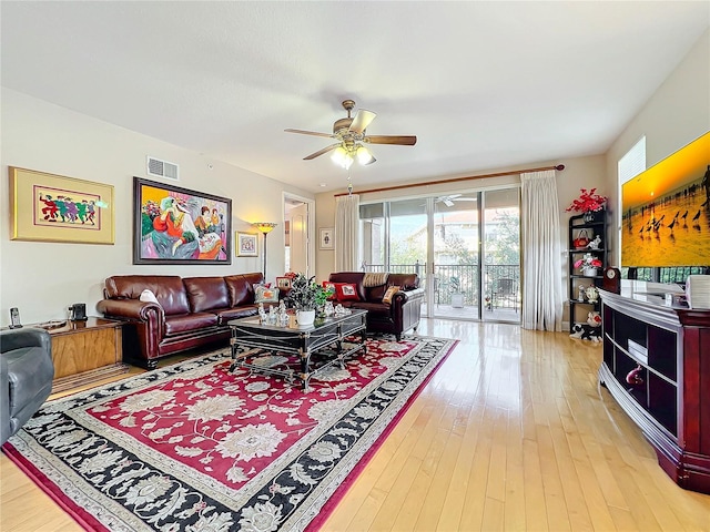 living room featuring hardwood / wood-style flooring and ceiling fan