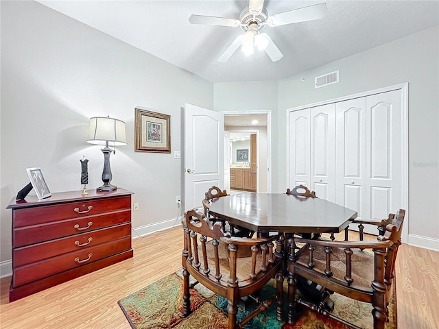 dining space featuring ceiling fan and light wood-type flooring