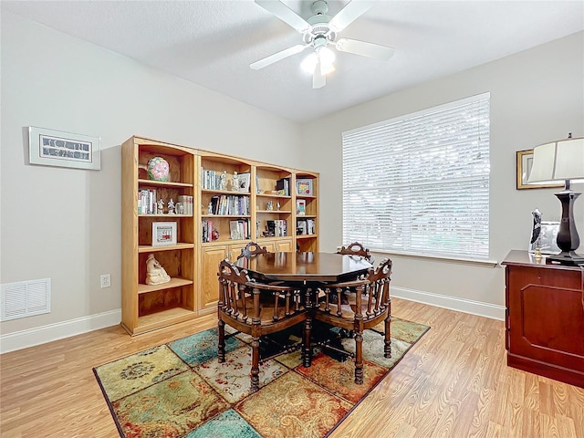 dining area with ceiling fan and light hardwood / wood-style flooring