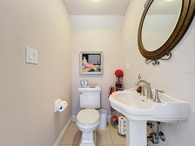 bathroom featuring tile patterned flooring, a textured ceiling, and toilet