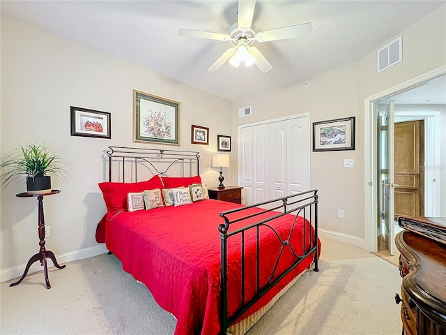 carpeted bedroom with a closet and ceiling fan