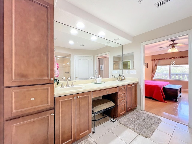 bathroom featuring vanity, tile patterned floors, ceiling fan, and walk in shower