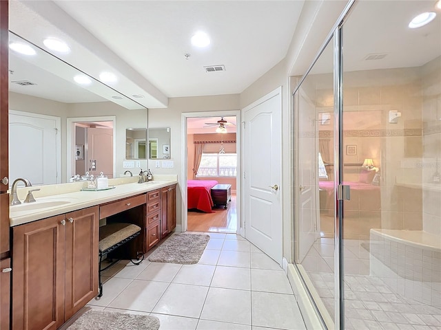 bathroom with tile patterned flooring, vanity, a shower with door, and ceiling fan