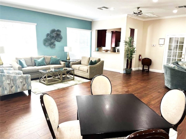 dining room with ceiling fan, ornamental molding, and dark hardwood / wood-style flooring